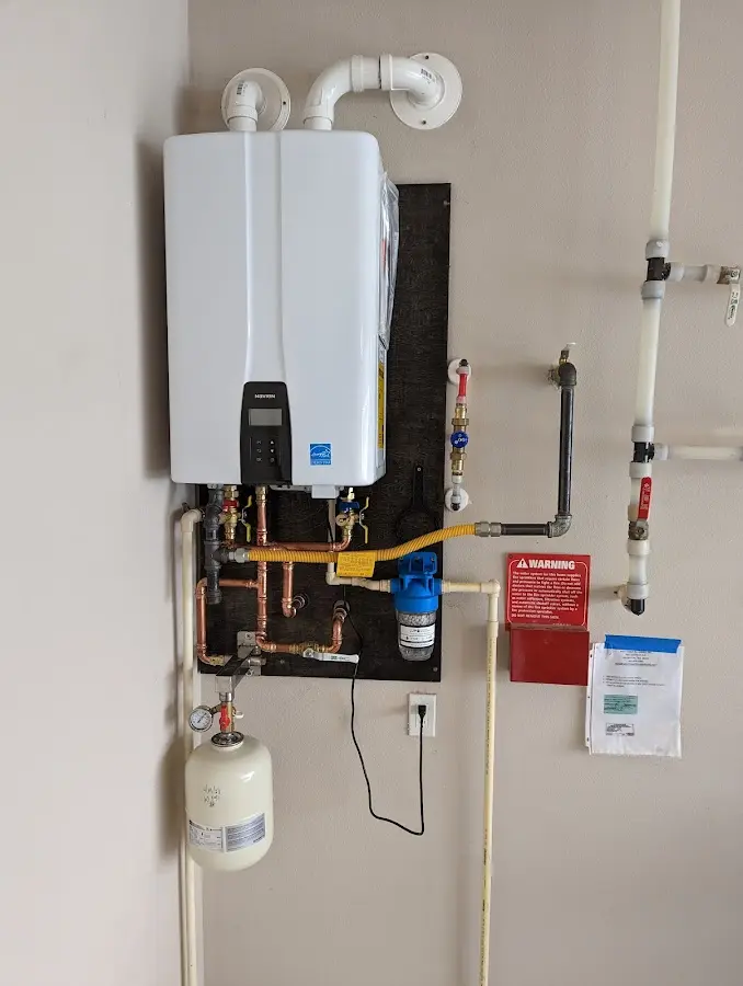 Professional plumber installing copper piping in a Creston home